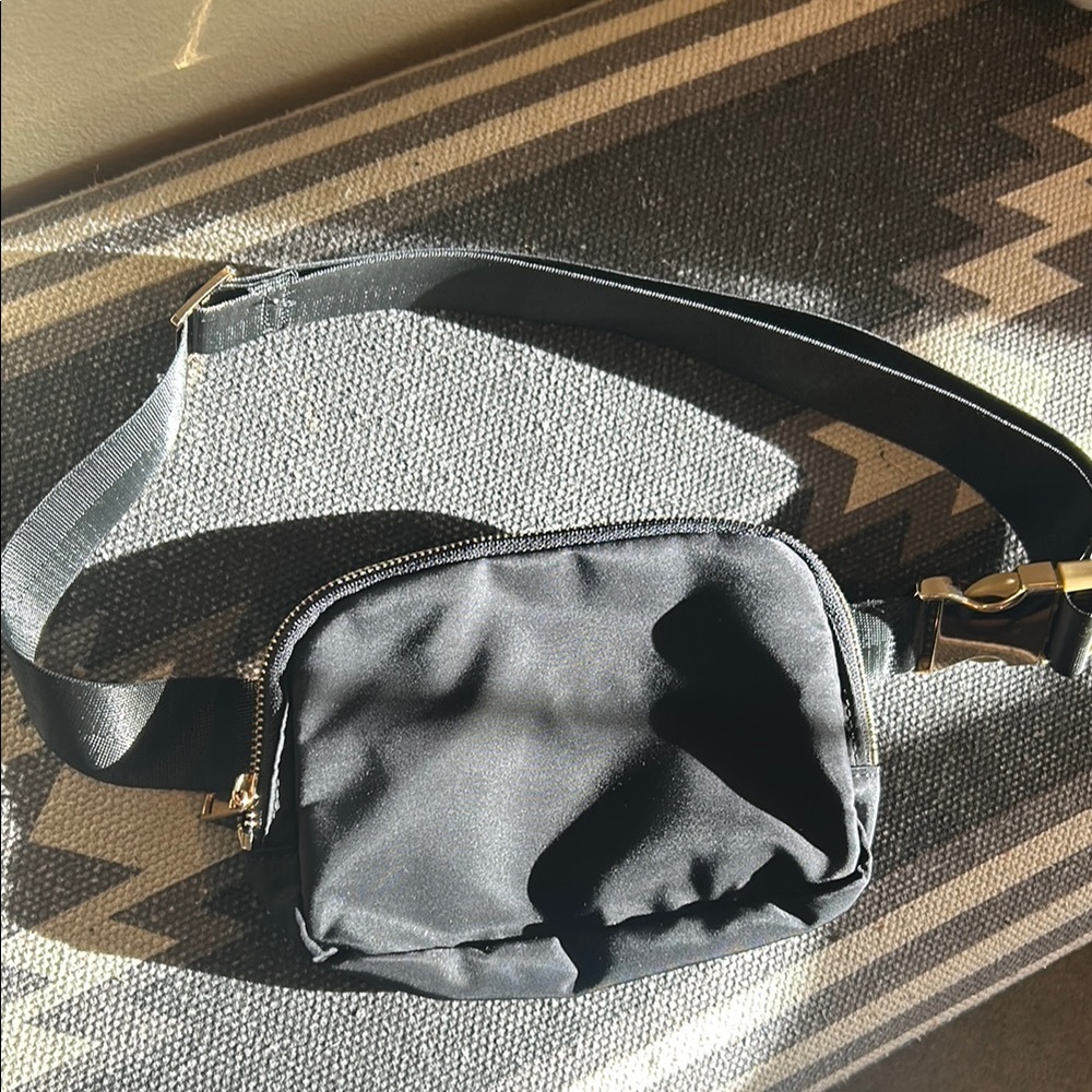 Black Crossbody Bag with Smooth Material and Gold Zipper